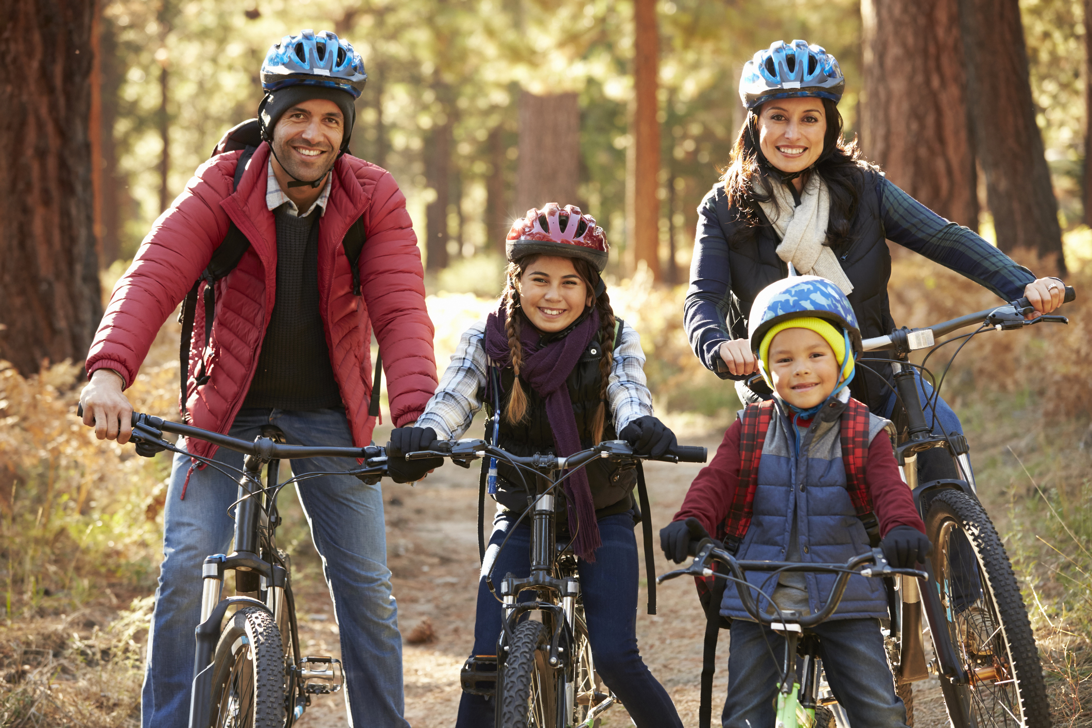 Portrait of Hispanic family on bikes in a forest