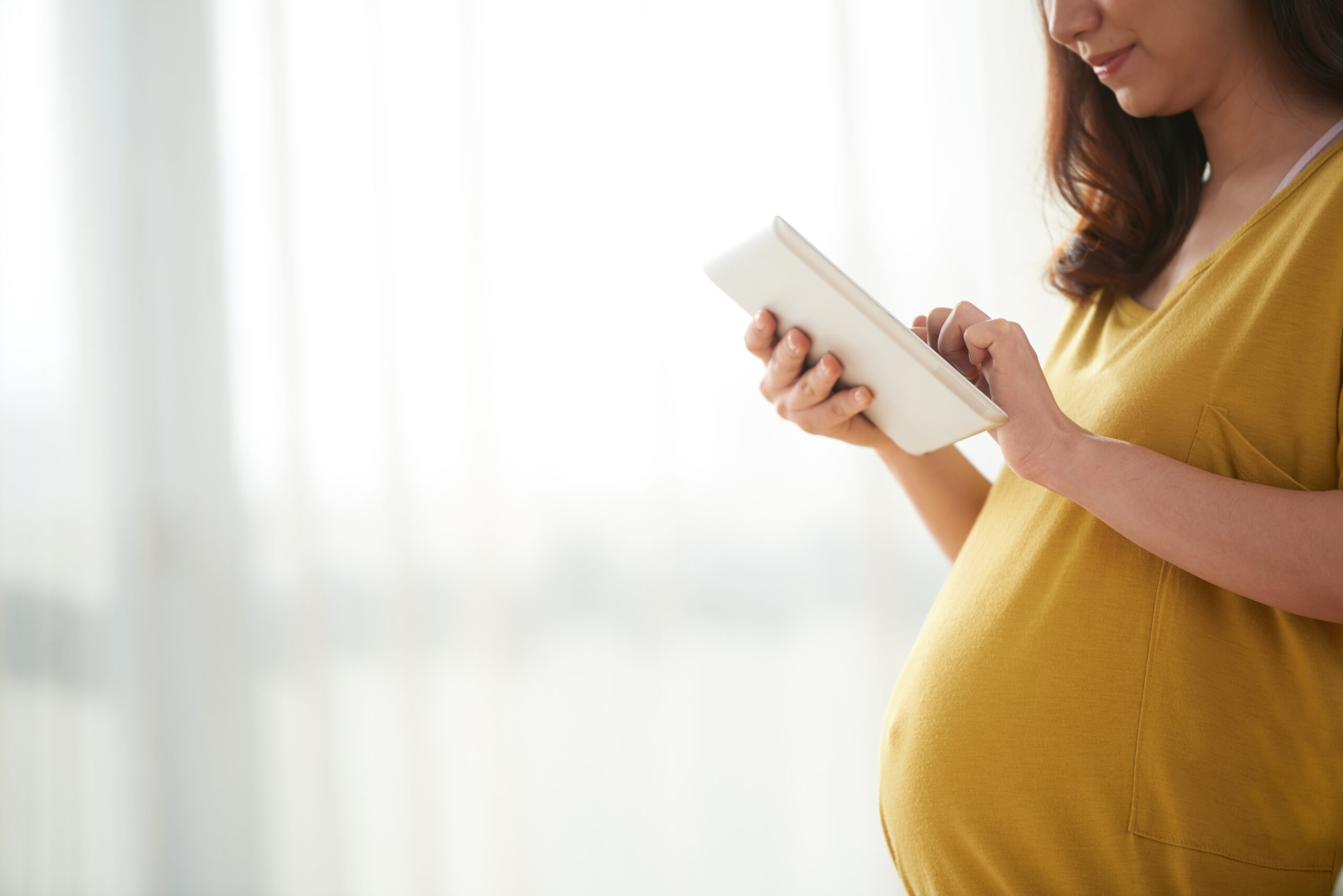 Pregnant woman with tablet