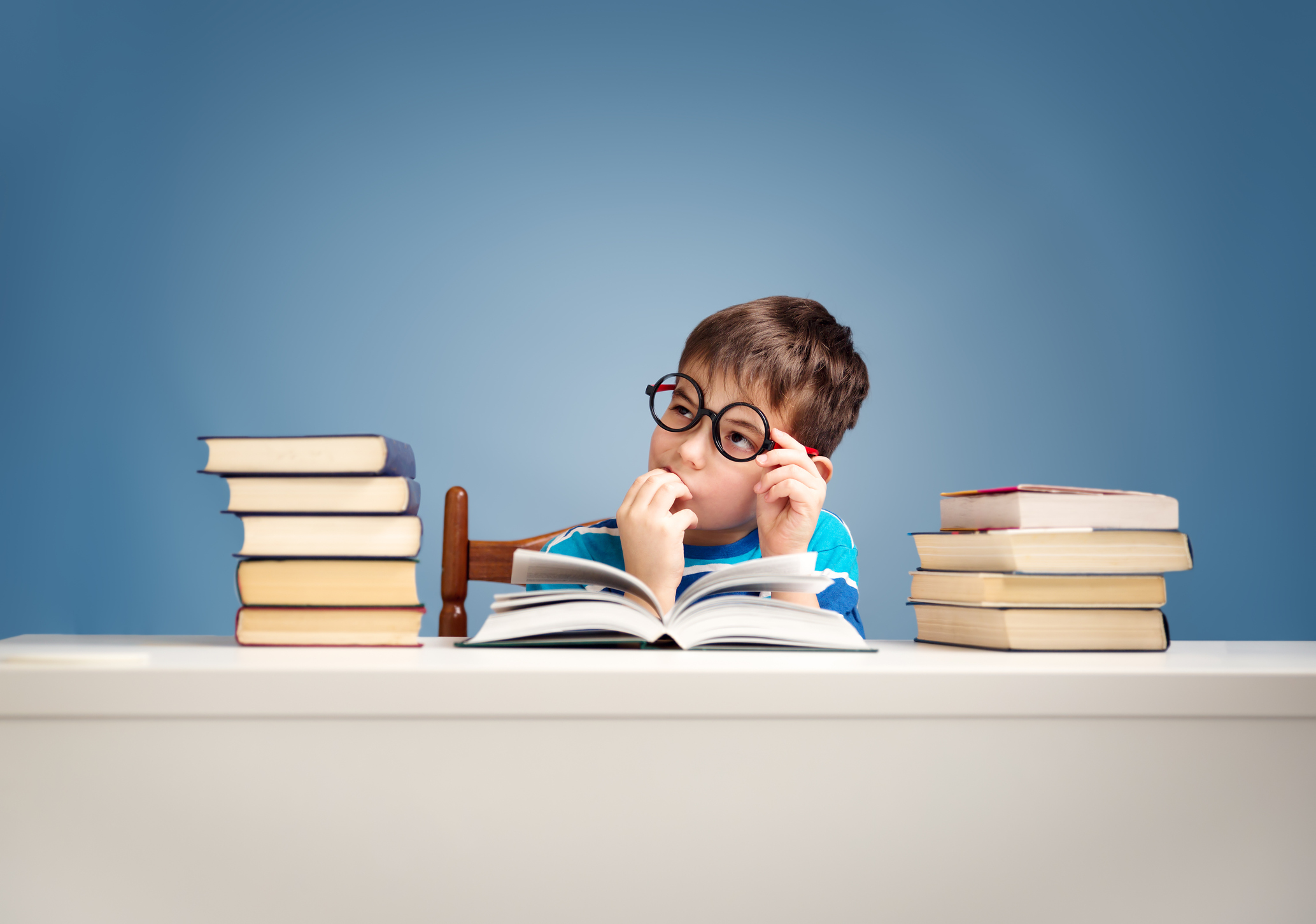 seven years old child reading a book