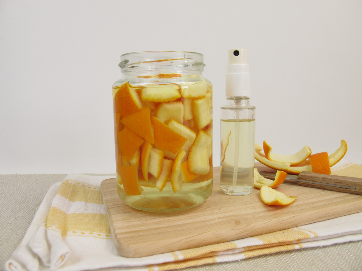 Organic household detergent with orange peel and vinegar in spray bottle