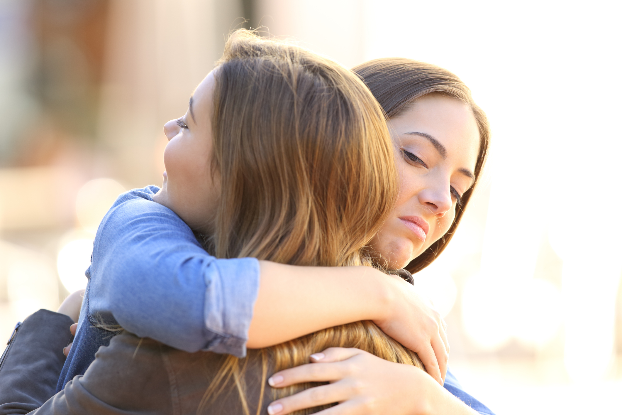 Hypocritical girl embracing a friend