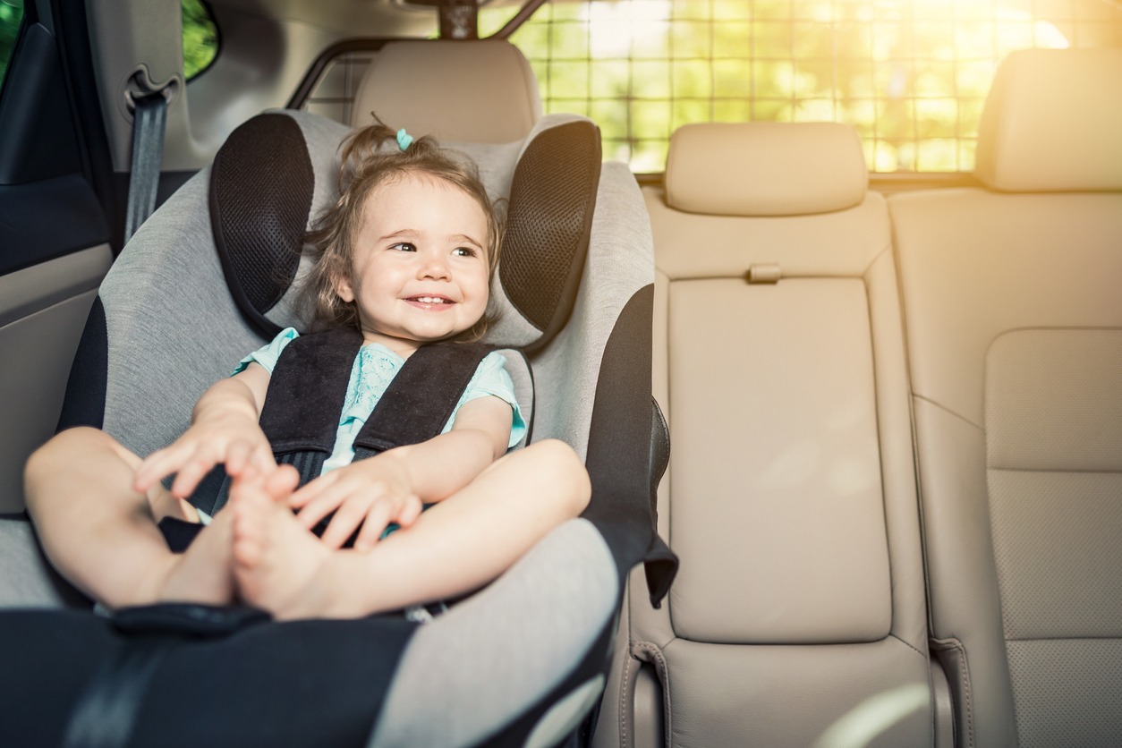 Infant baby girl buckled into her car seat.