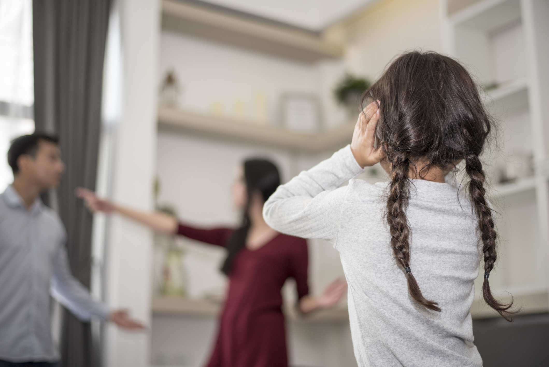 Little girl puts her hands on her ears because she does not want to hear her dad and mom quarrel. close ears, Family Dramatic scene, Parrents issues, Social and parrents problem concept