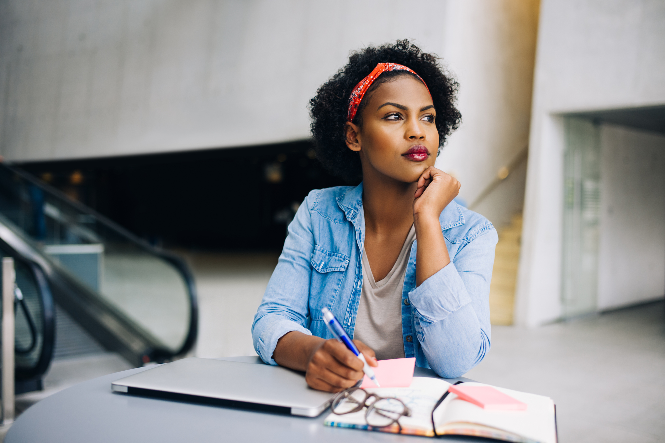 Young African female entrepreneur dreaming up new business ideas