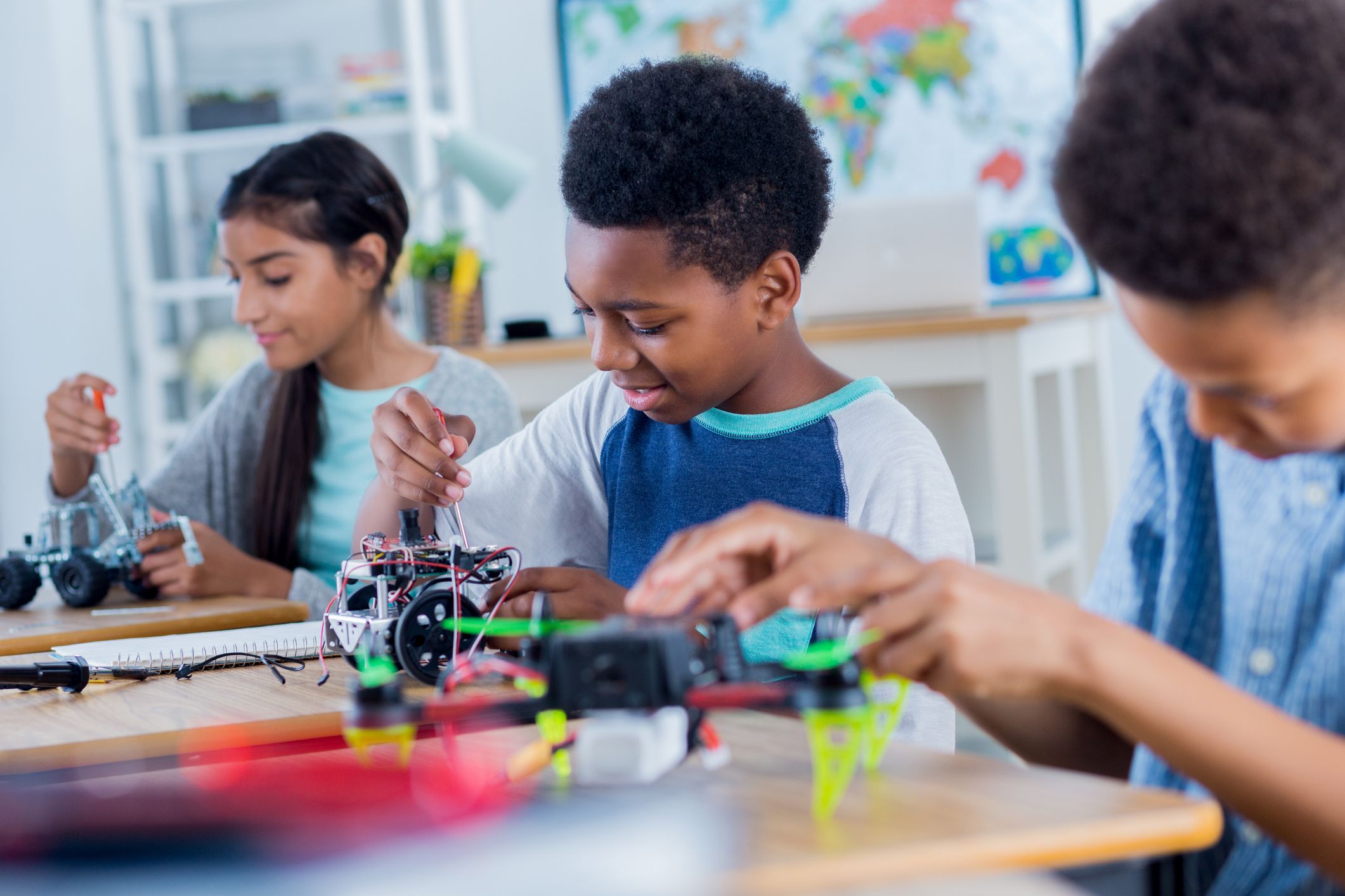 Group of middle school students work on robotics project