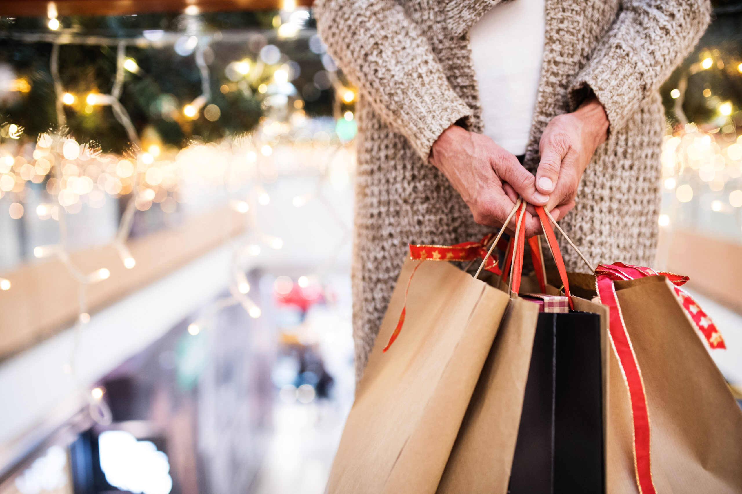 Senior woman with bags doing Christmas shopping.