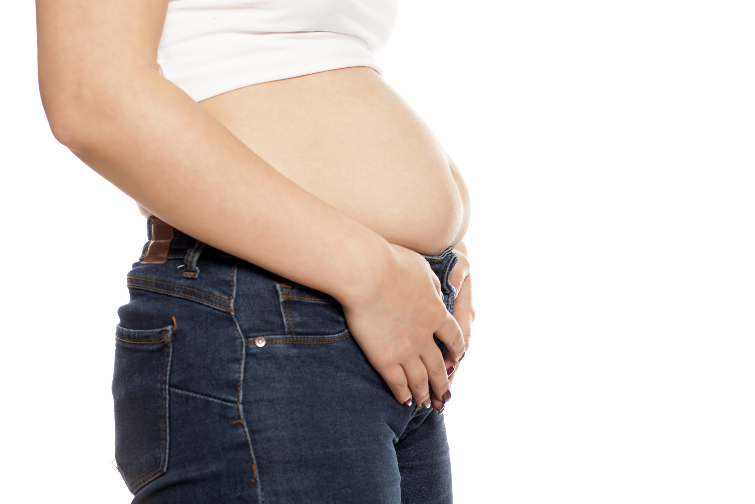 the woman shows her stomach that has risen from overeating