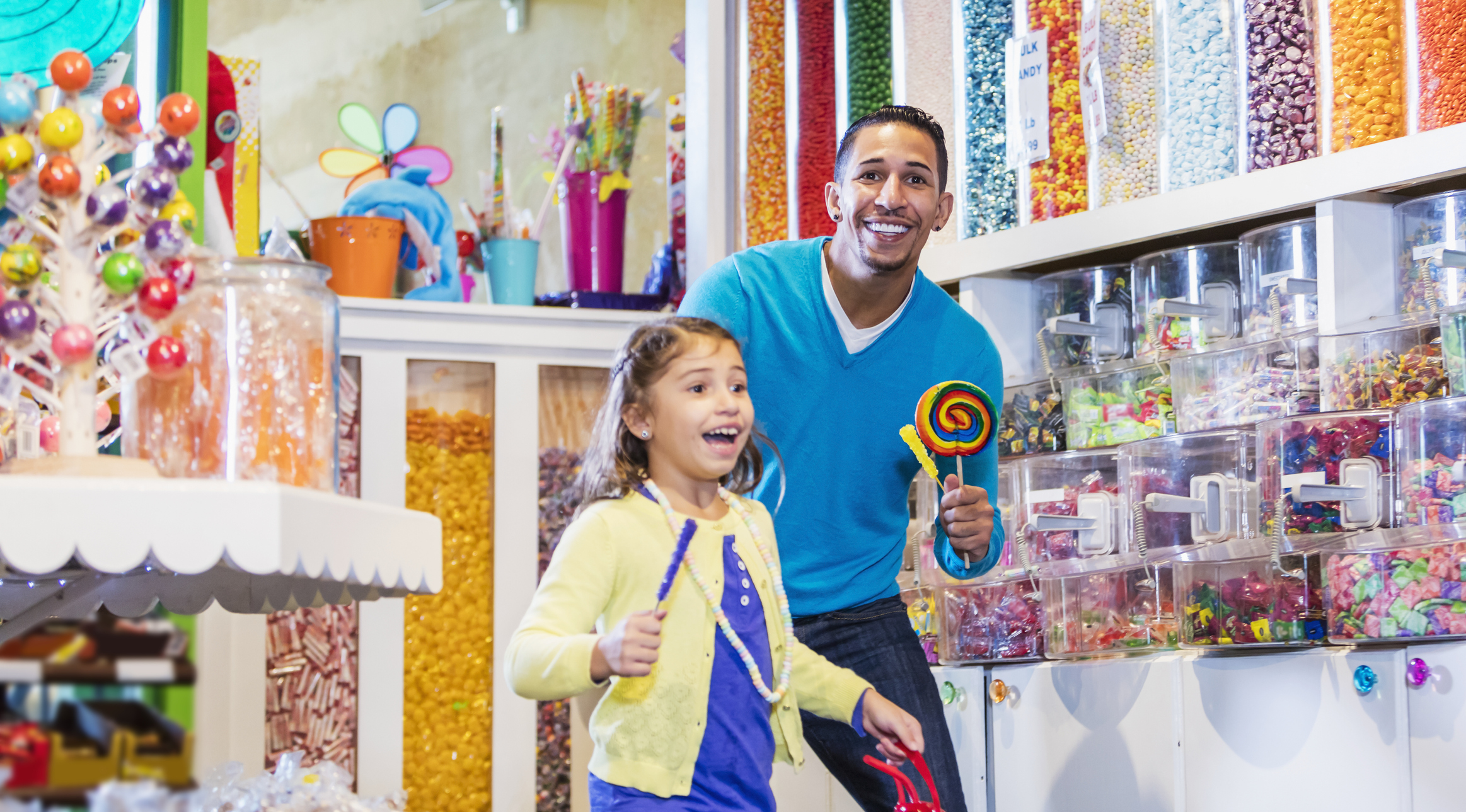 Girl and father in candy store