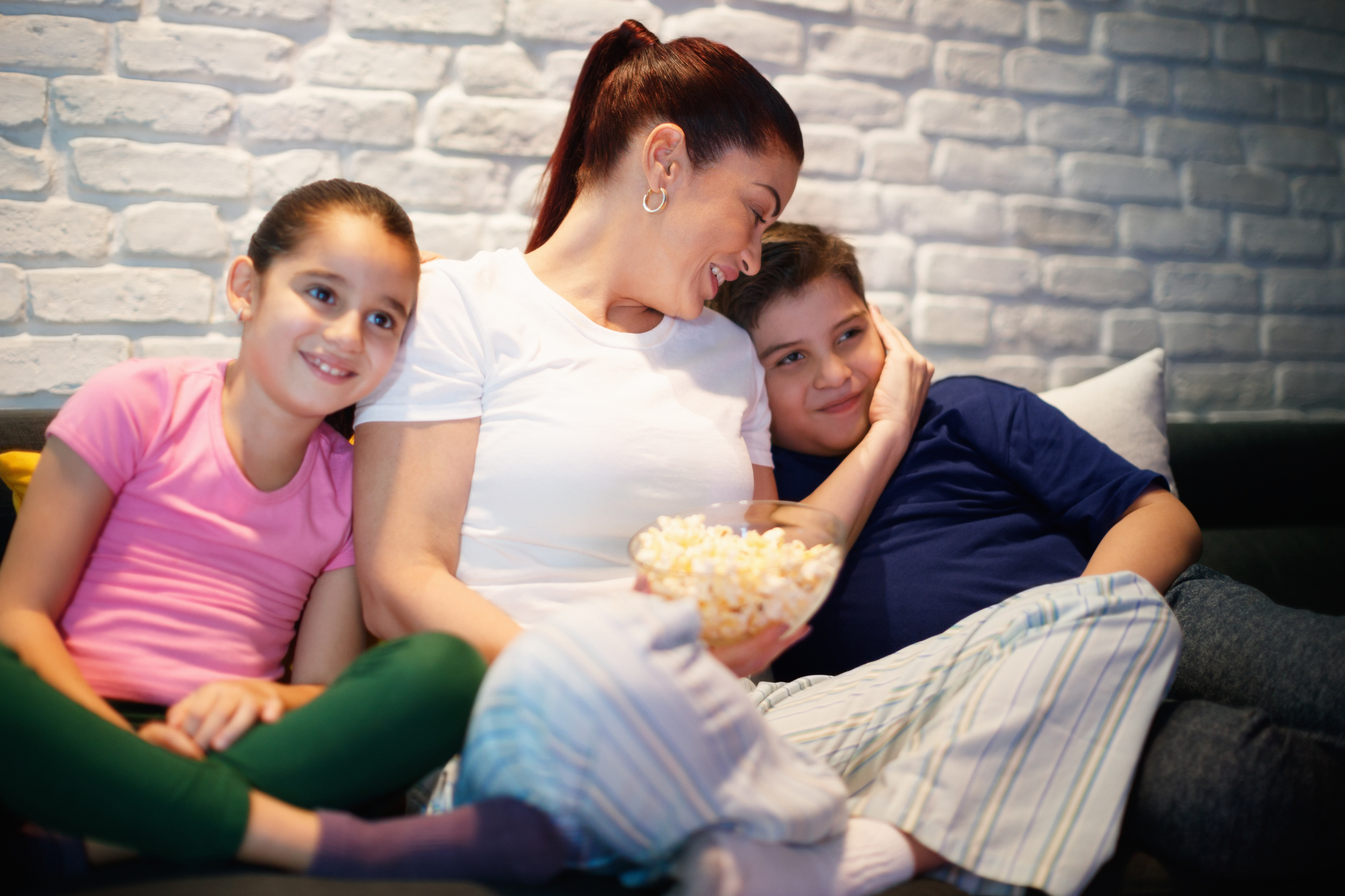 Single Mother And Children Watching TV At Night