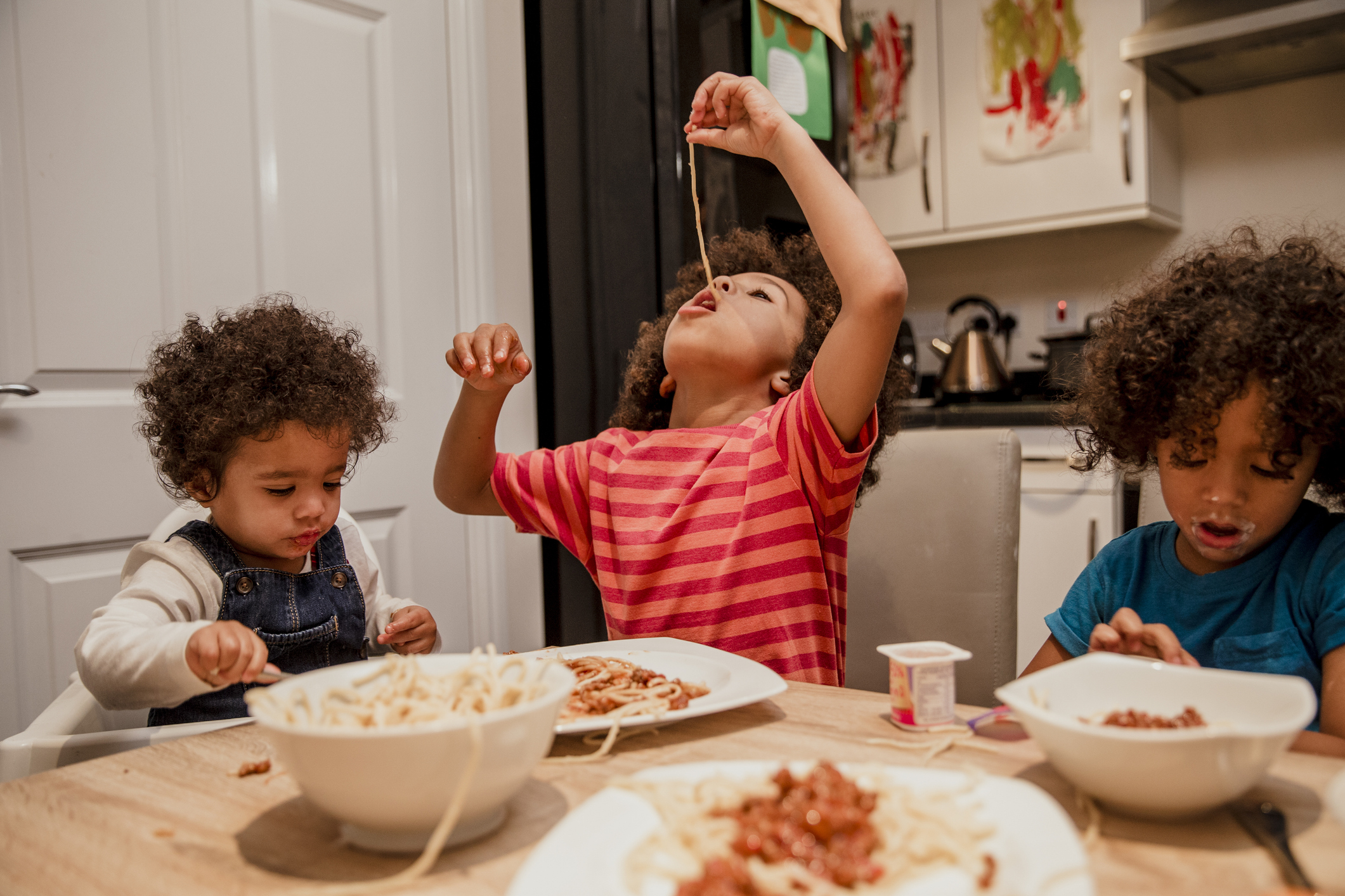 Children Eating Spaghetti and Yoghurt