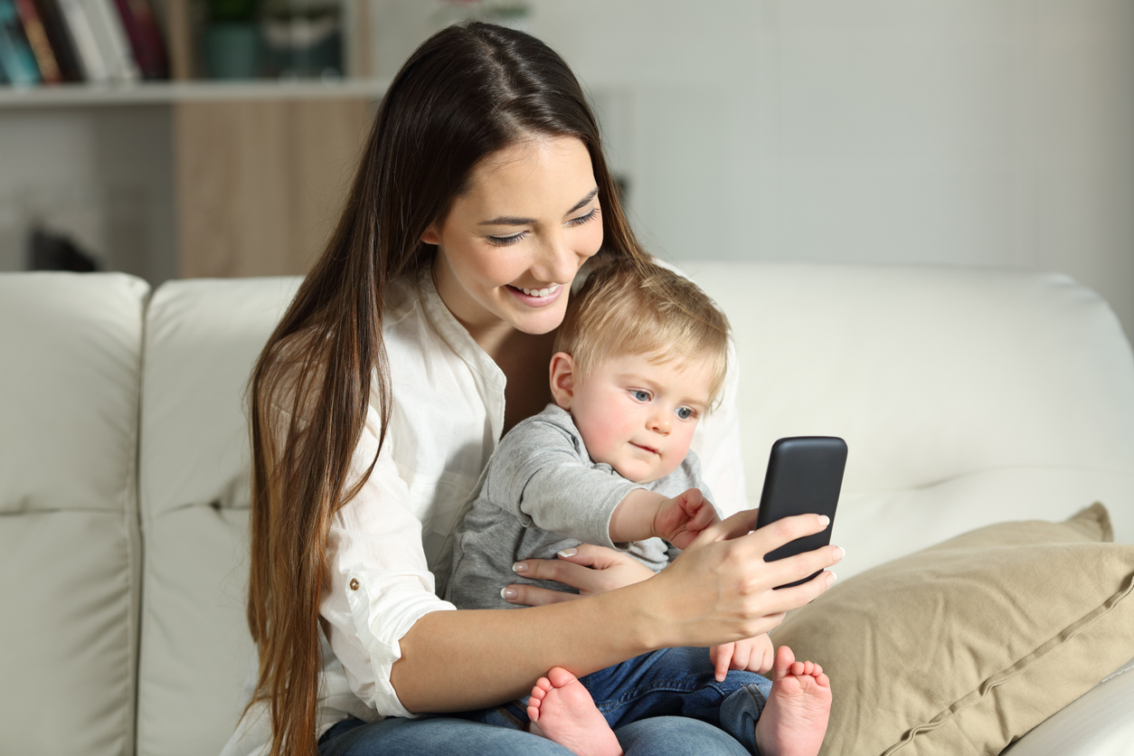 Mother and baby playing with a smart phone