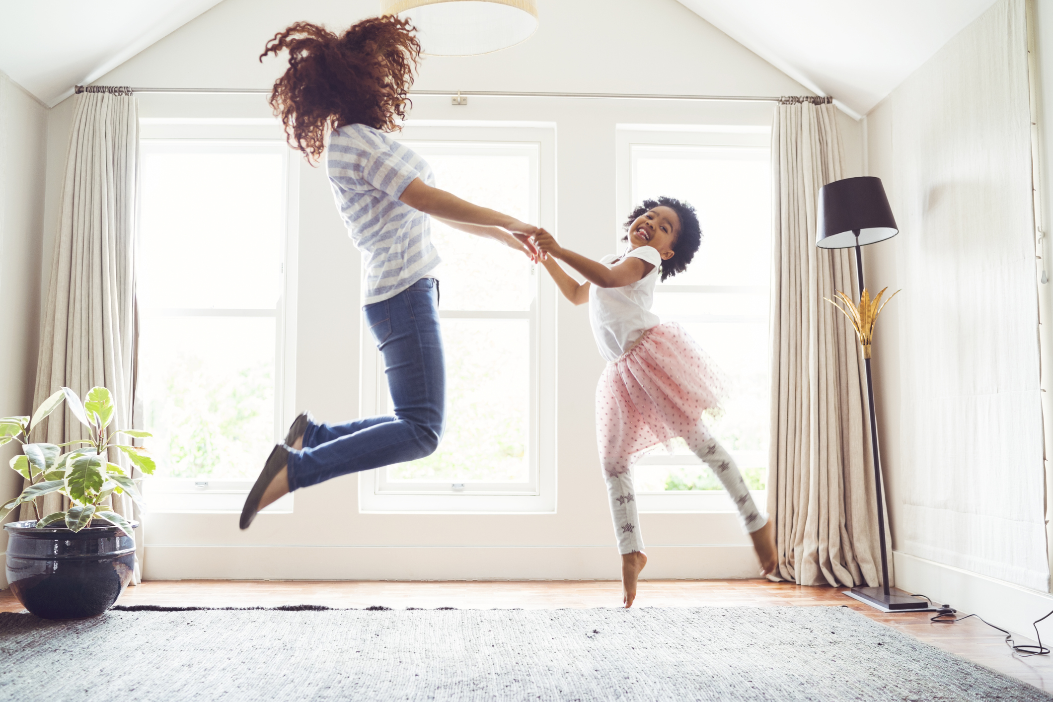 Mother and daughter jumping while doing ballet