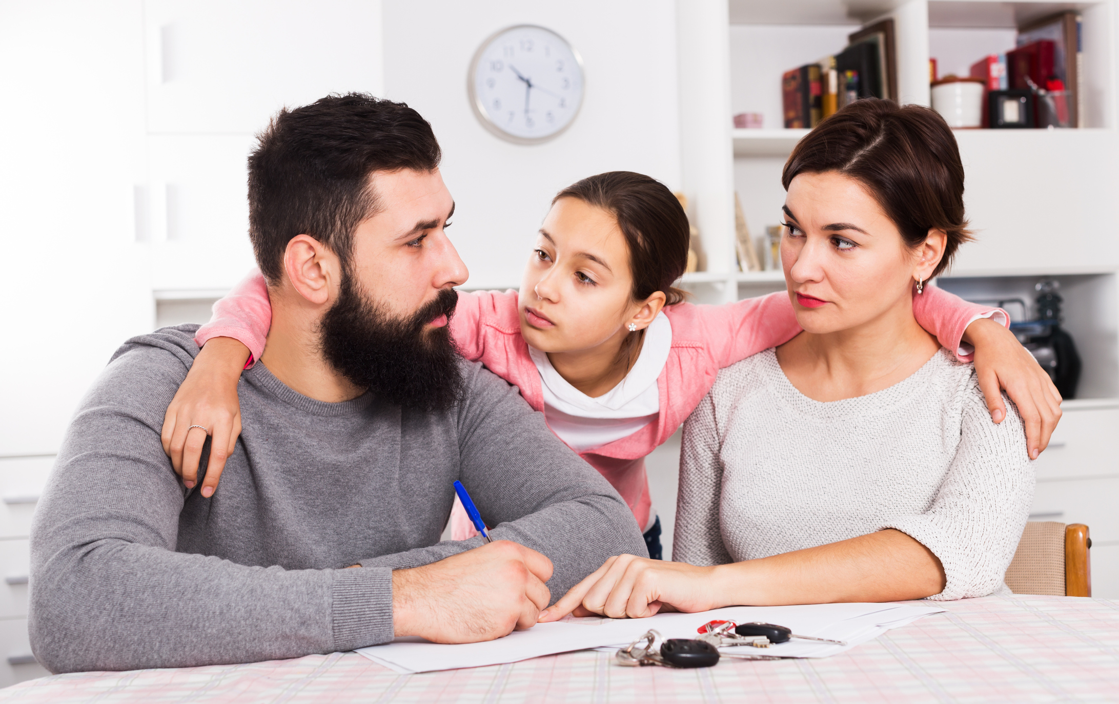 Parents signing papers for divorce