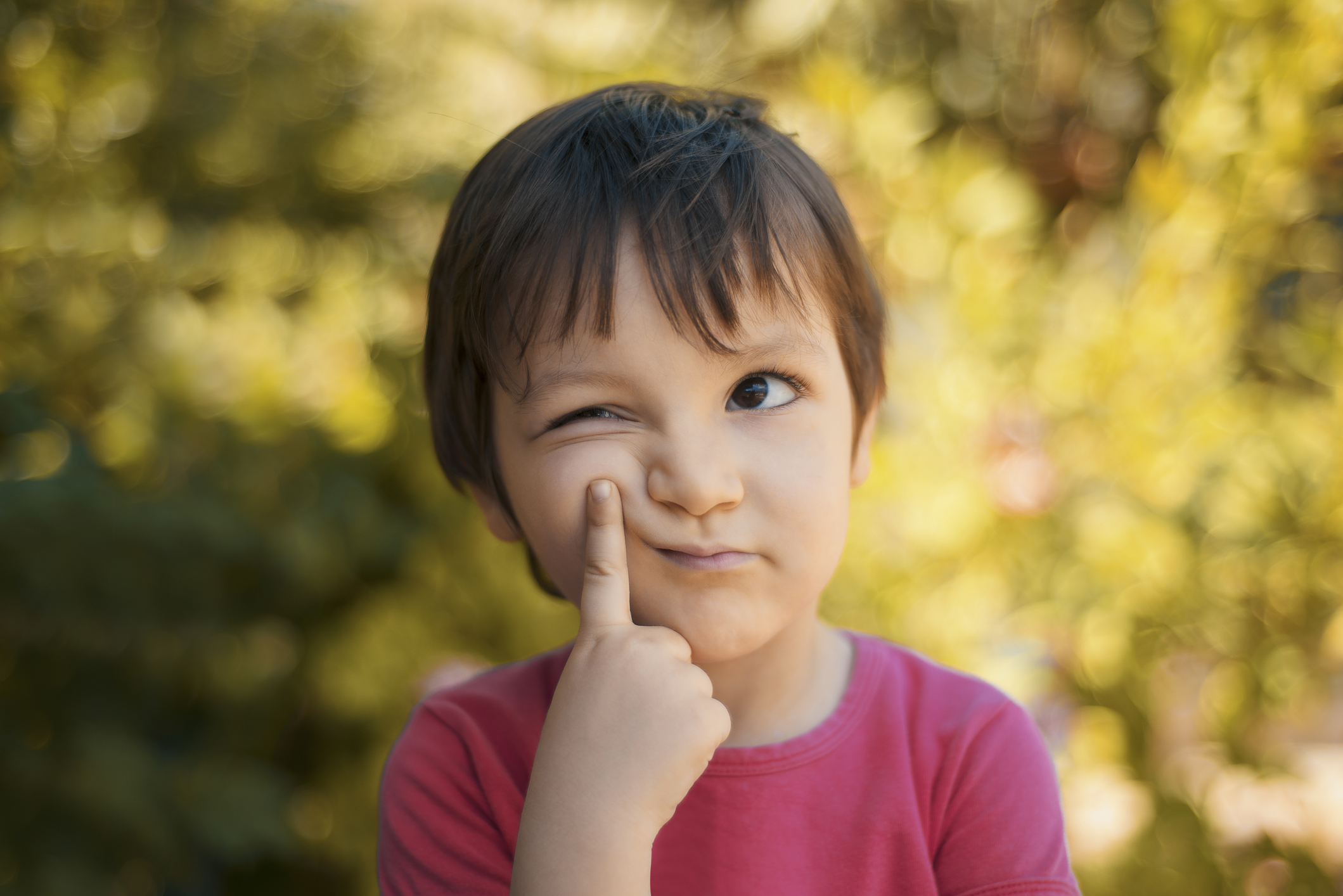 Close-up portrait of thinking little girl looking away with thoughtful facial expression