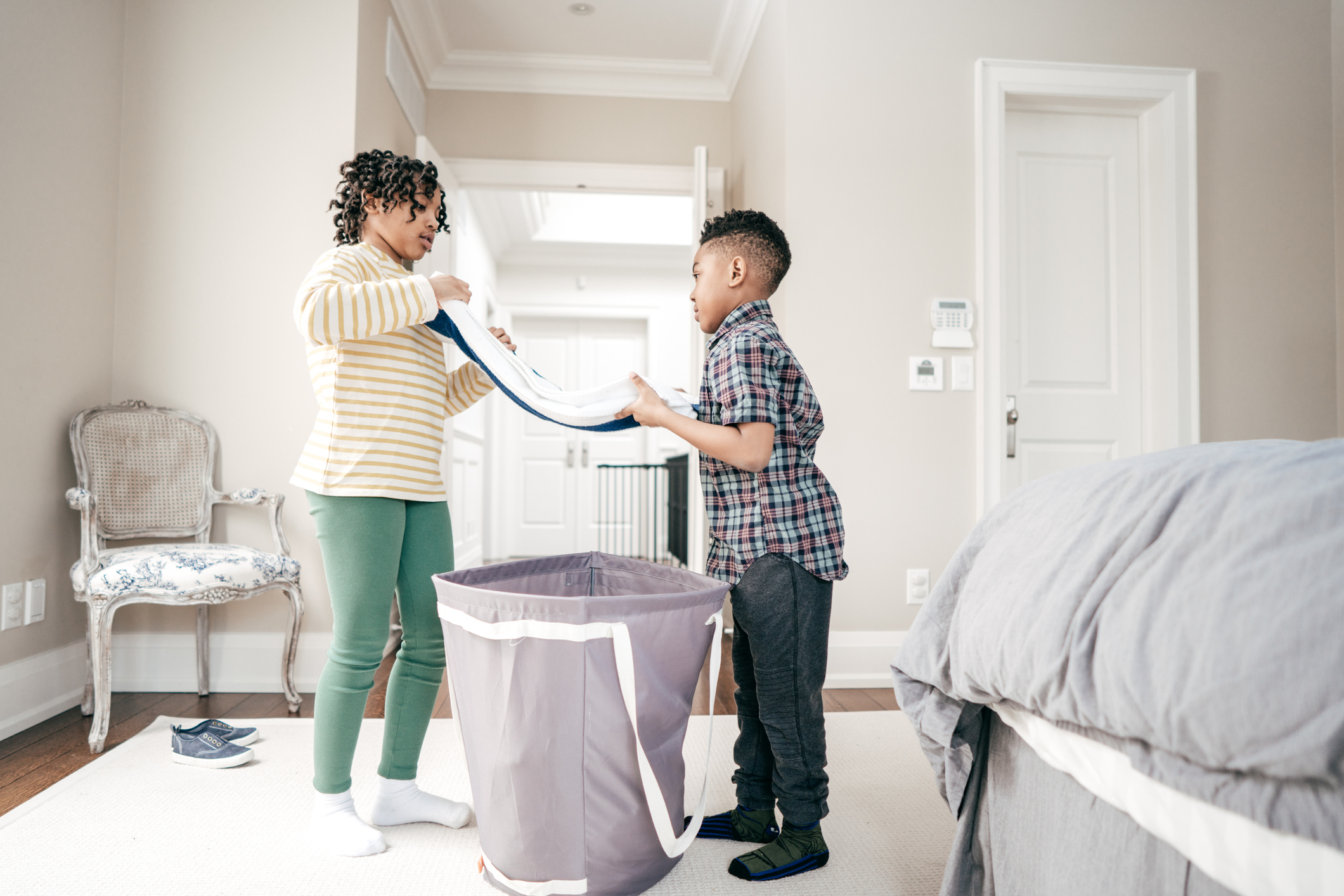 Siblings folding laundry