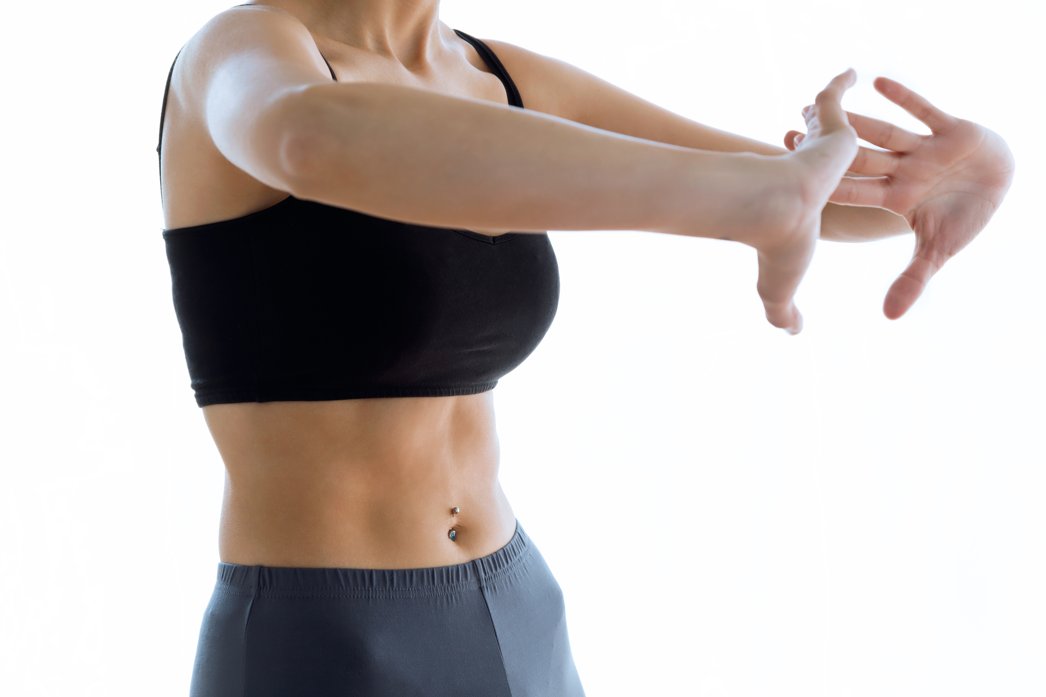 Sporty young woman doing hypopressive abs indoor.