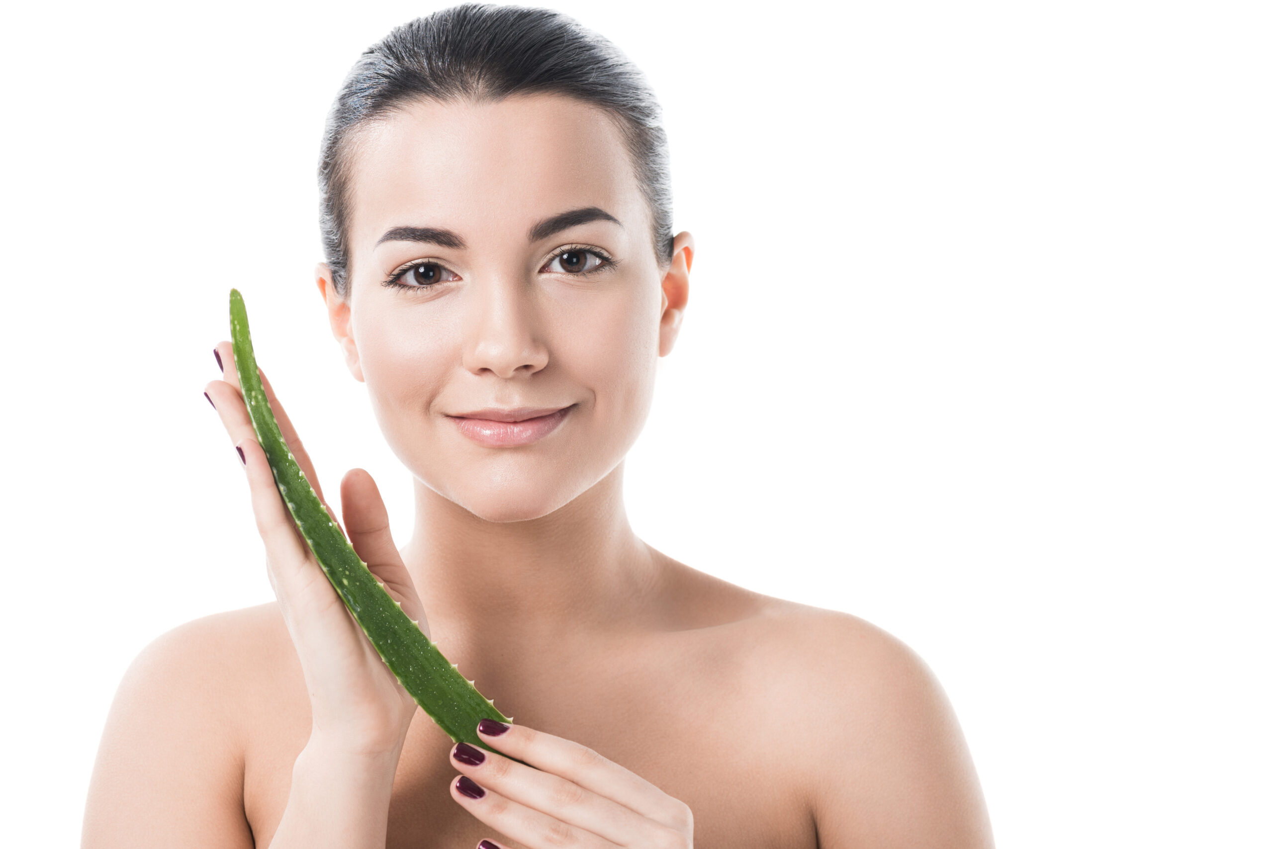 beautiful girl holding aloe vera leaf and looking at camera isolated on white