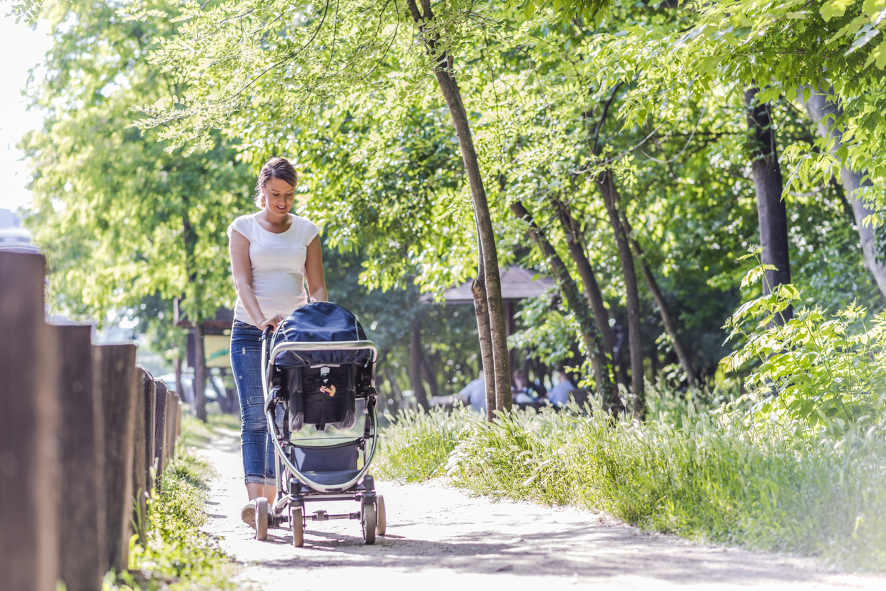 Mother pushing daughter in stroller