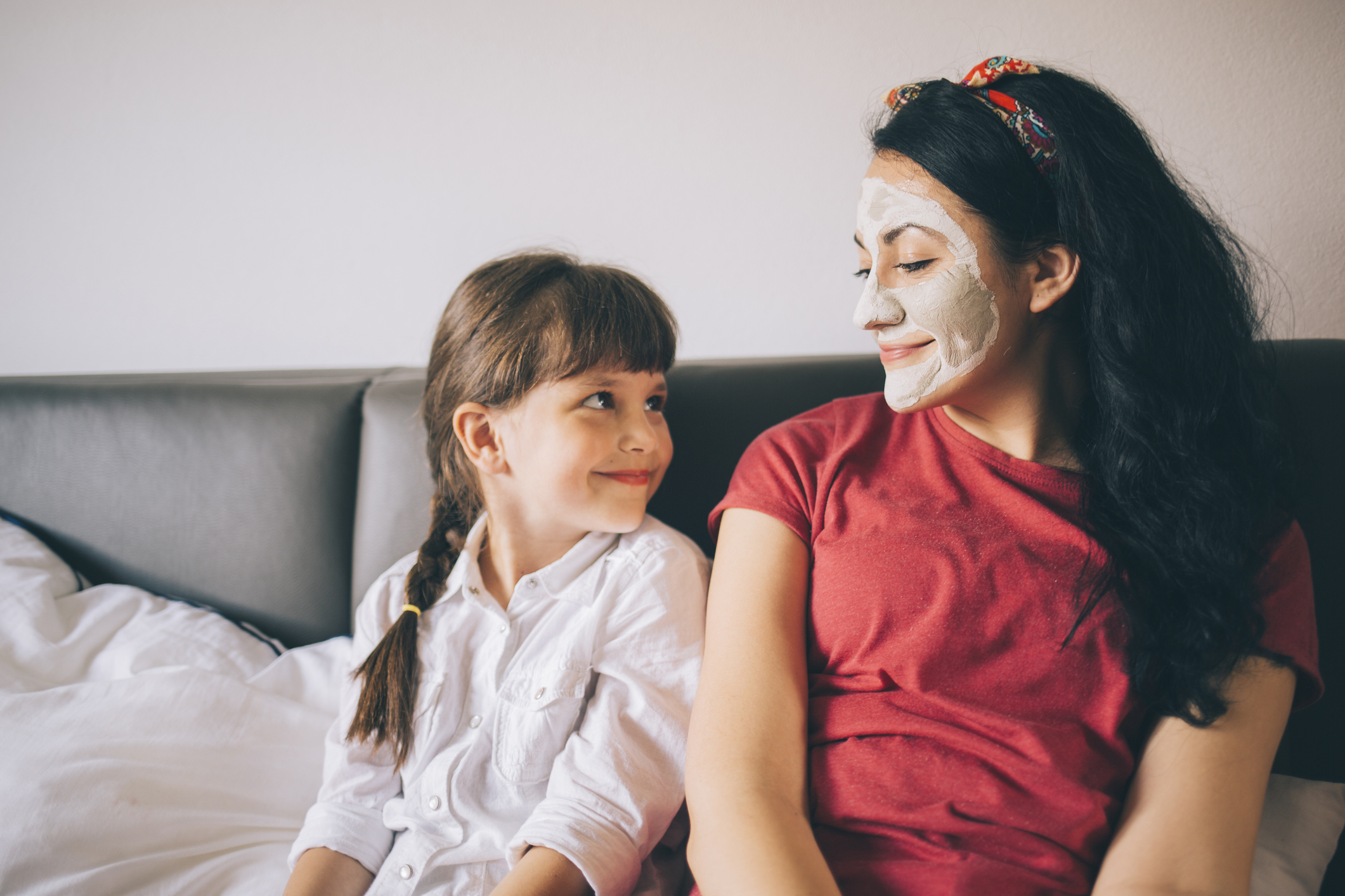 Mother with child doing beauty treatment together.