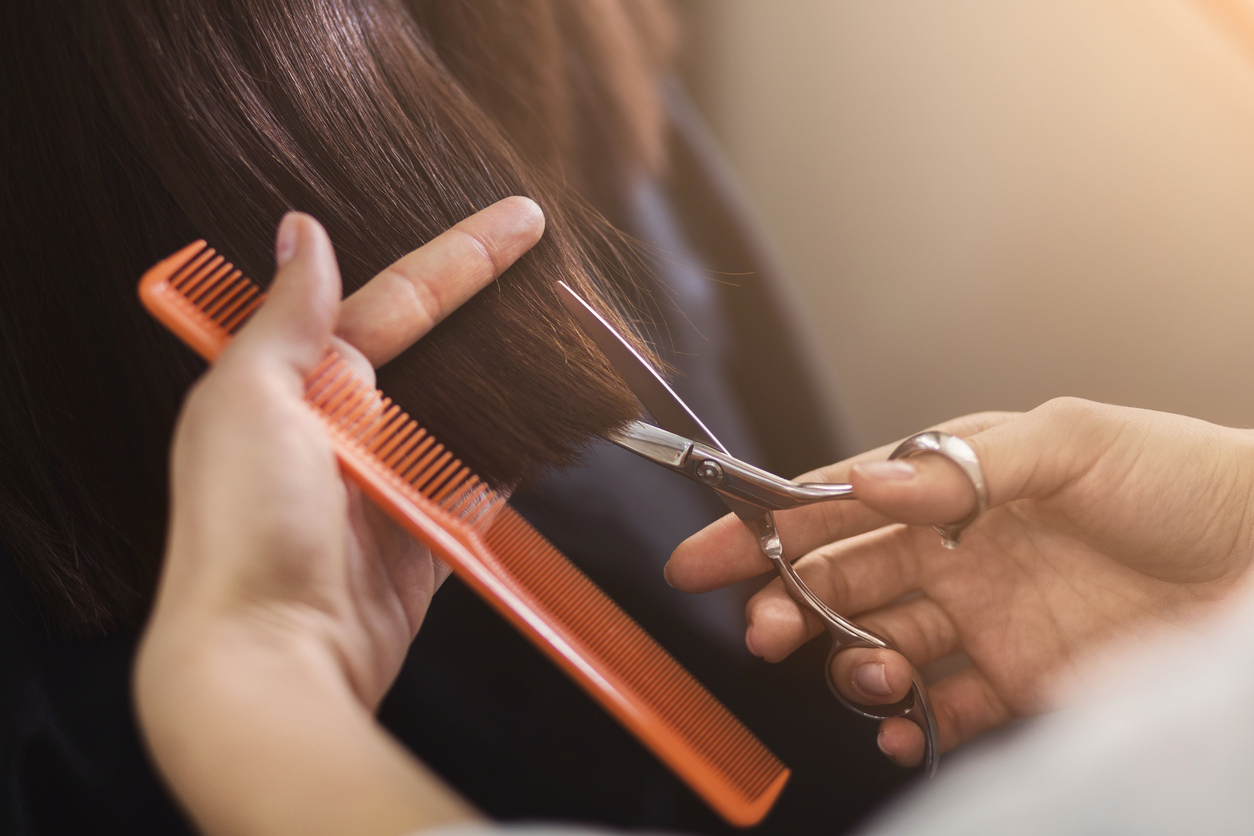 Cropped shot of female client receiving a haircut