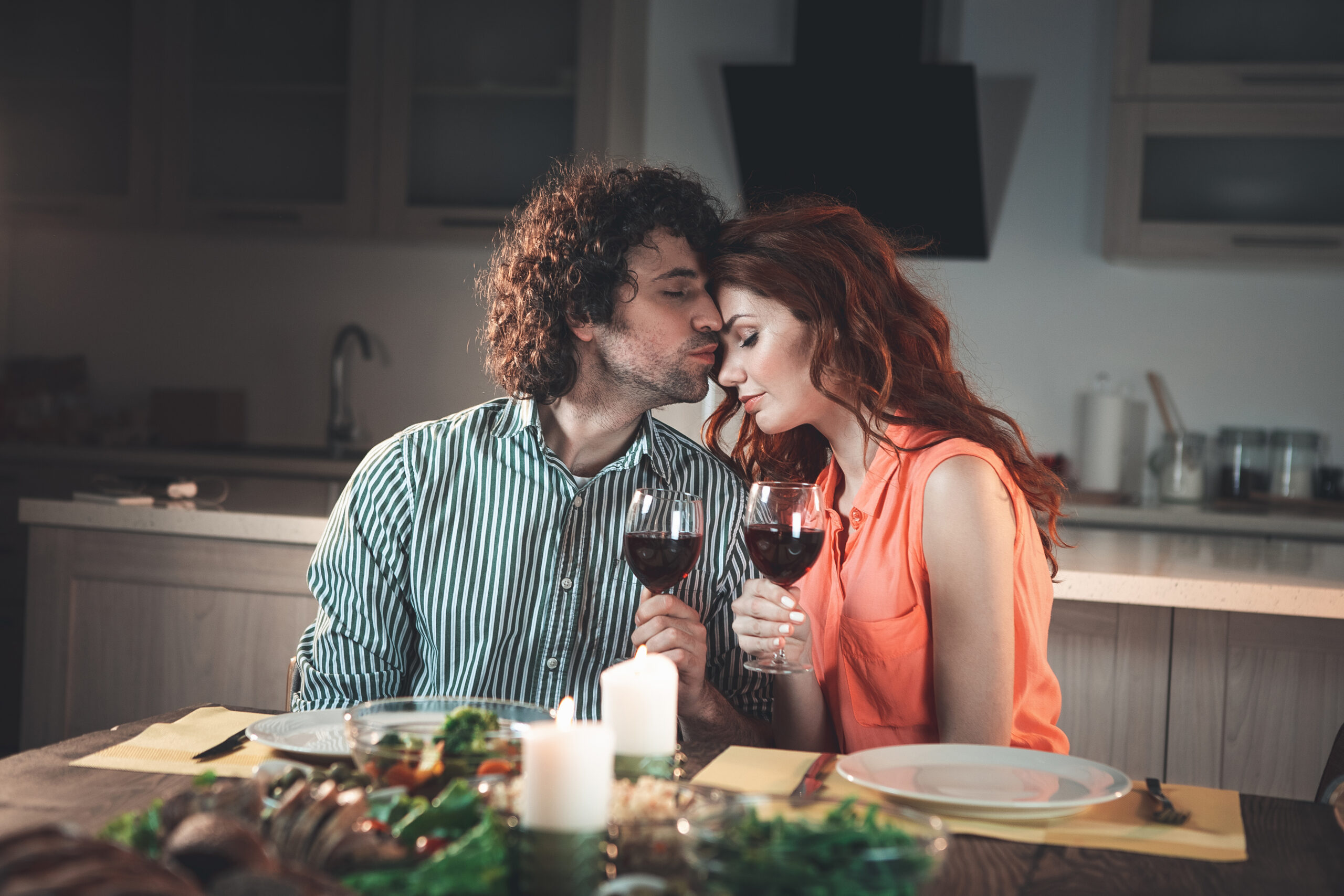 Relaxed loving couple having candlelight dinner