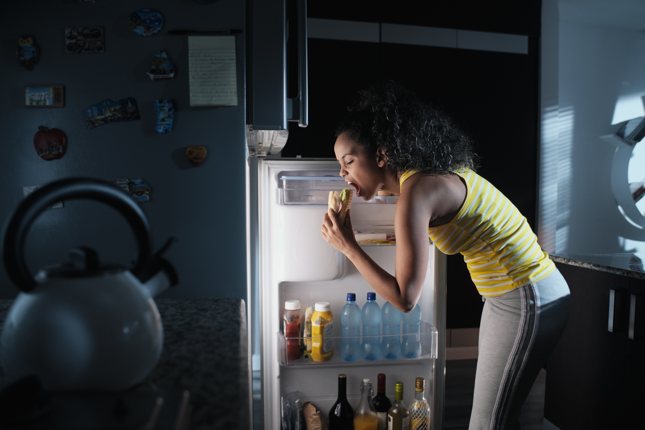 Black Woman Looking into Fridge For Midnight Snack