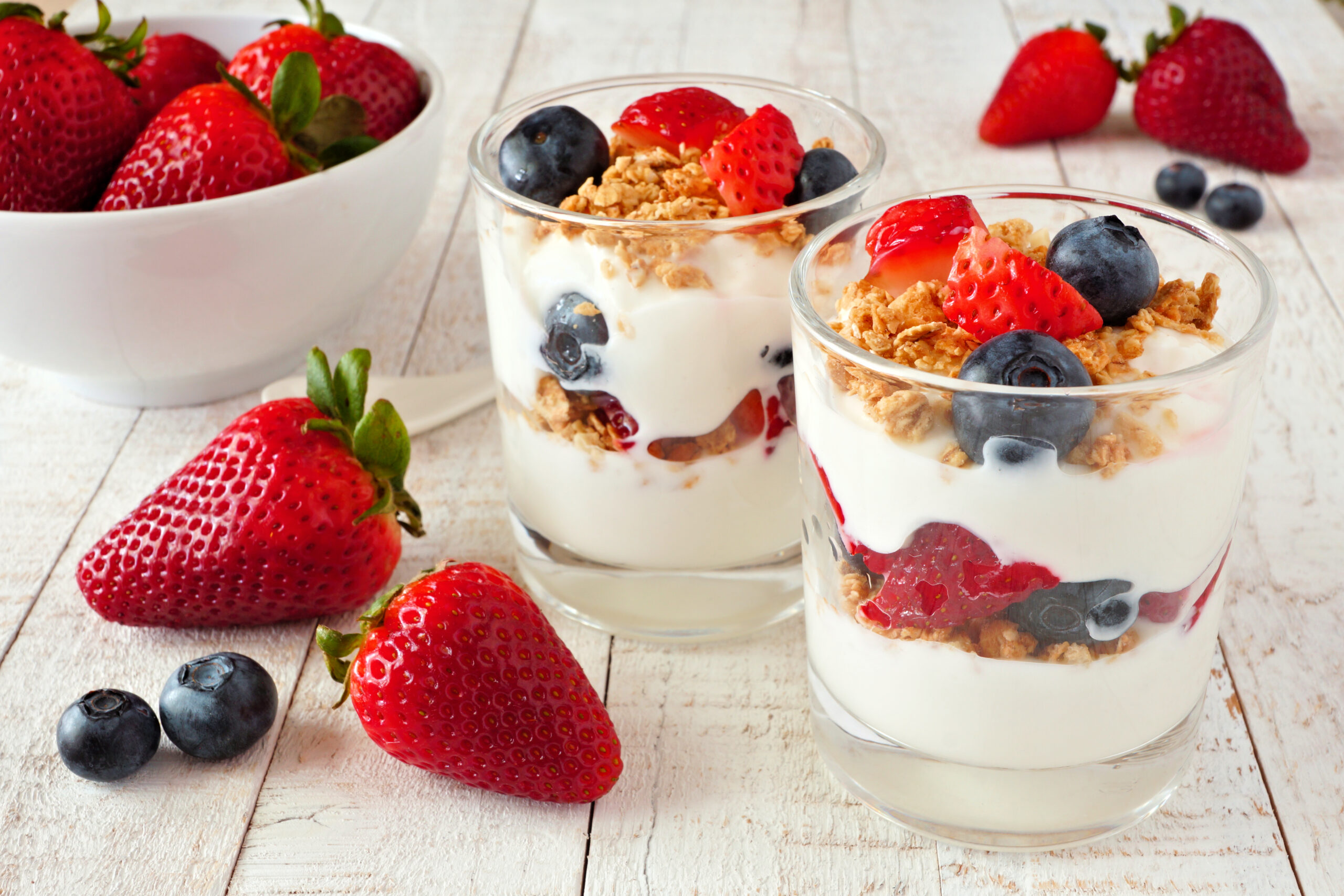 Strawberry and blueberry perfect against a white wood background