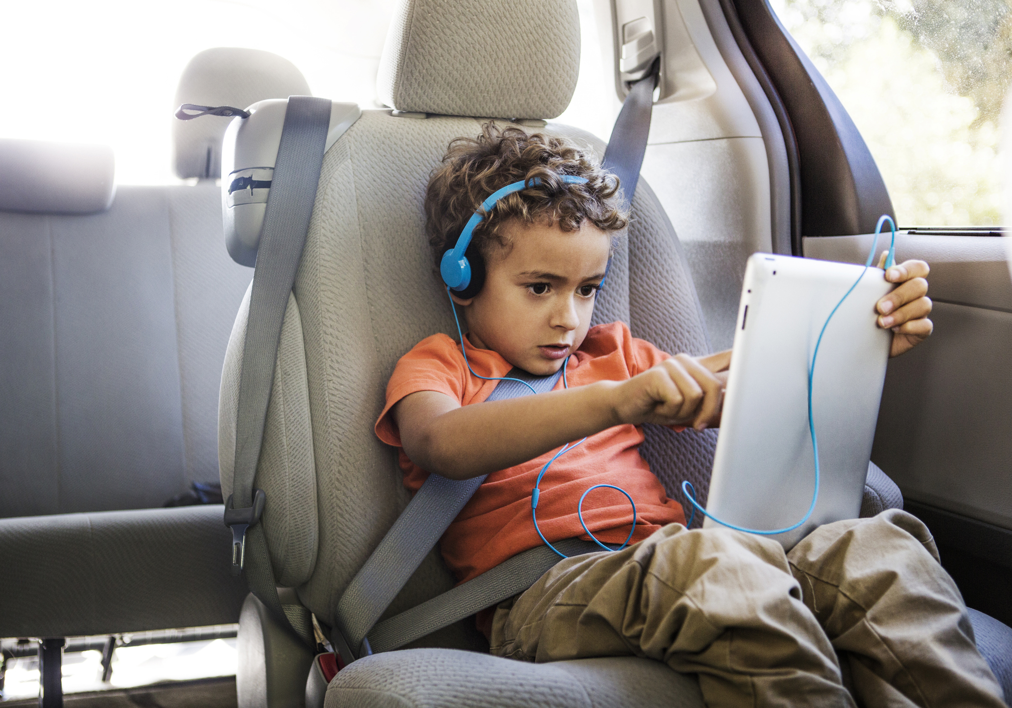 boy on tablet in car