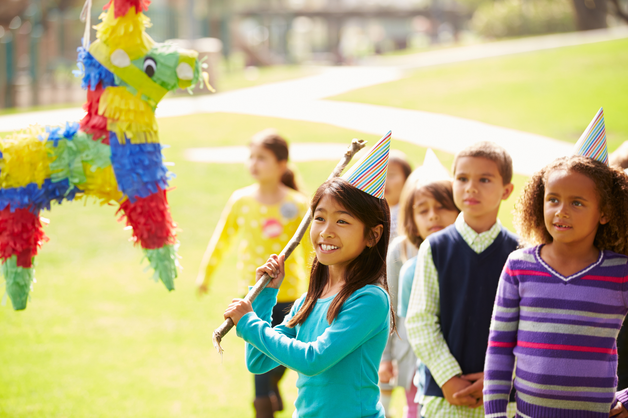 Children Hitting Pinata At Birthday Party