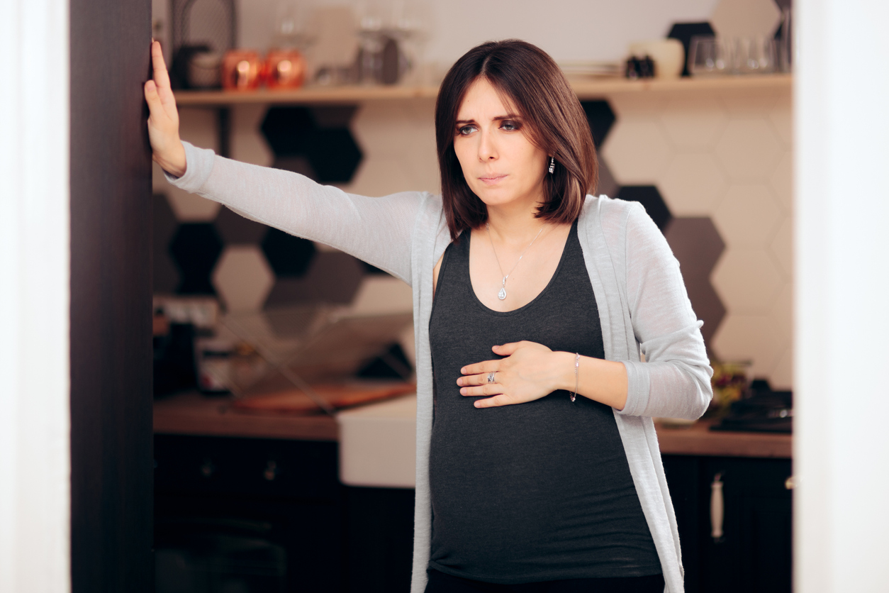 Pregnant Woman Feeling Sick in Her Kitchen