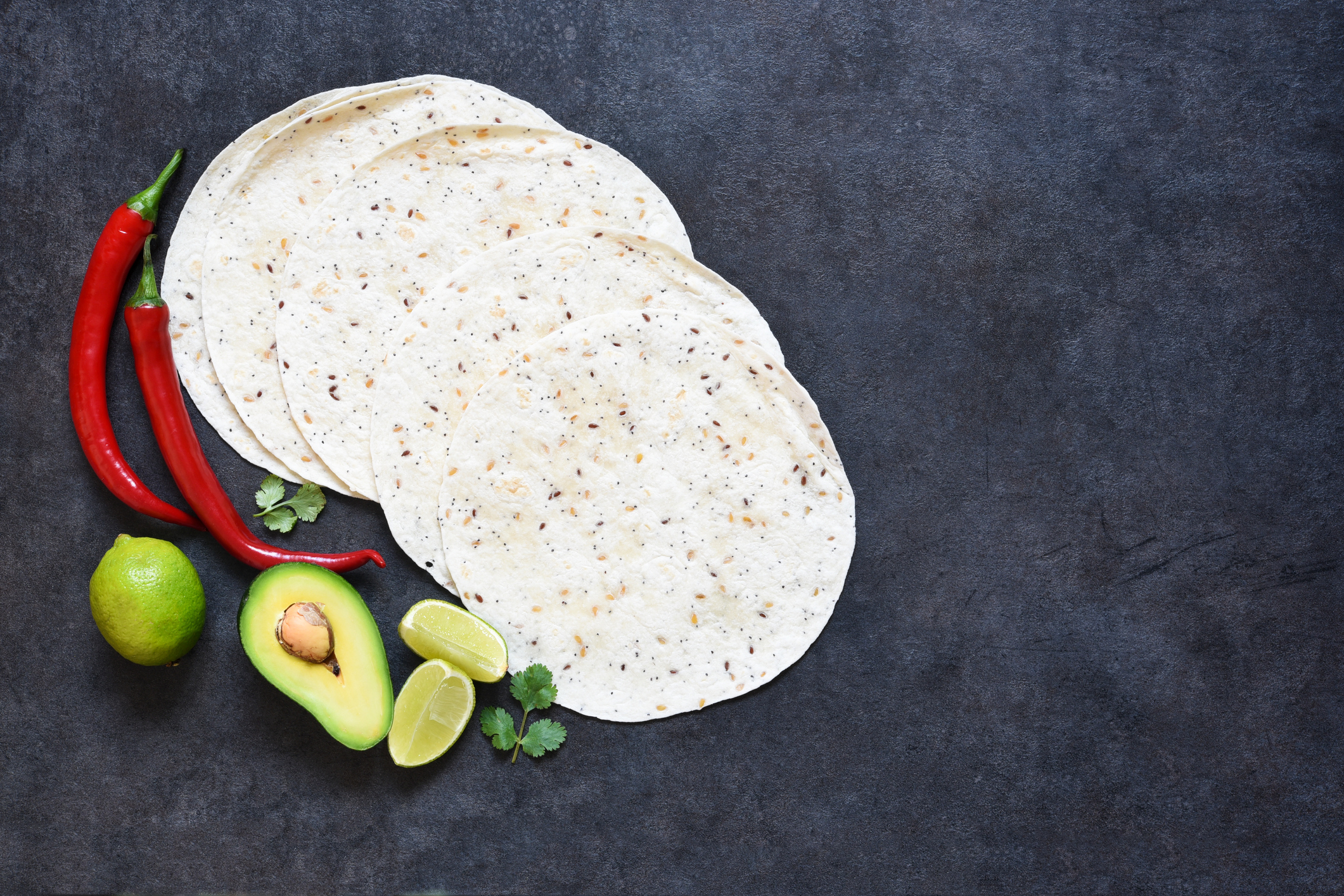 Corn tortilla for making tacos with chili and avocado. Ingredients for cooking quesadillas.