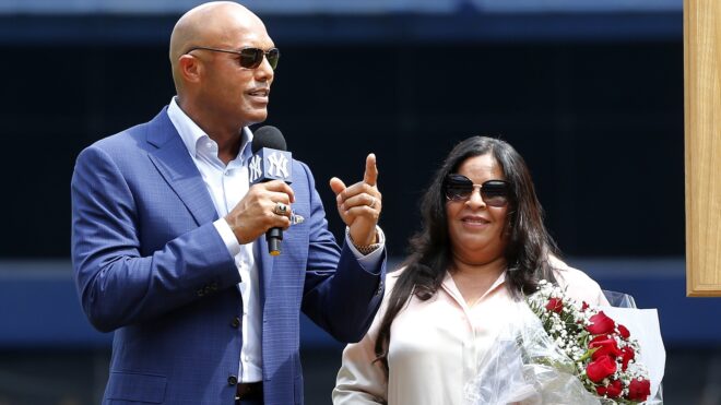 Mariano Rivera speaks to the crowd as he stands with his wife Clara next to his Hall of Fame plaque during a ceremony in his honor before a game between the Yankees and the Cleveland Indians at Yankee Stadium on August 17, 2019 in New York City.