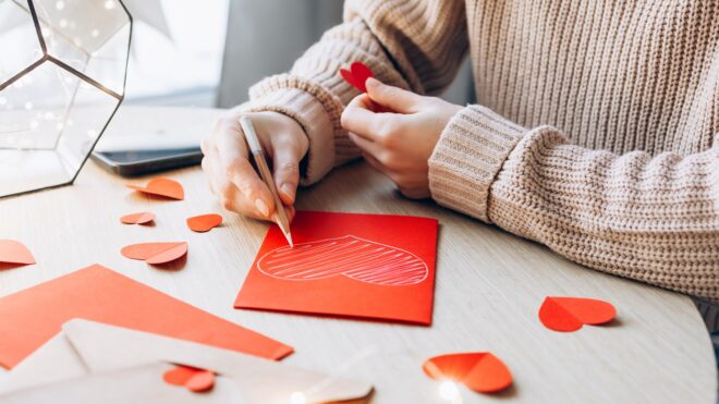 Young woman writing a Valentine card