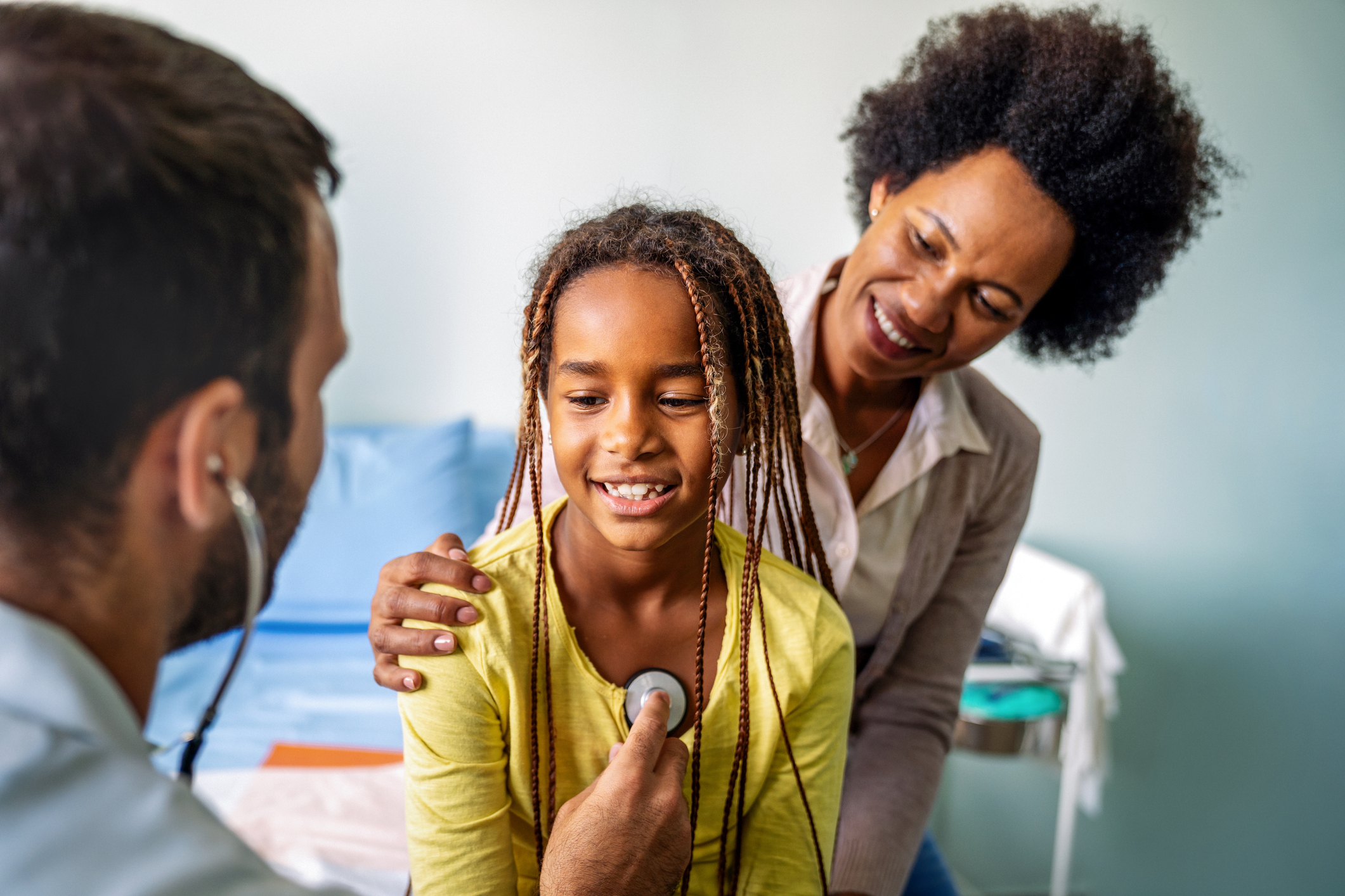 Healthcare medical exam people child concept. Close up of happy girl and doctor with stethoscope