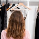 Rear view of a woman at her home closet