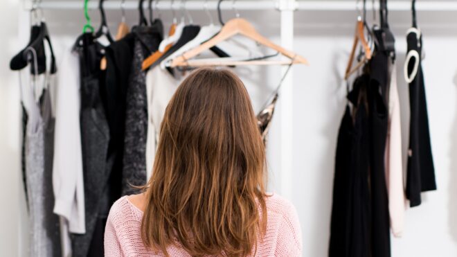 Rear view of a woman at her home closet