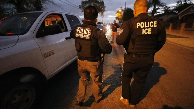 ICE agents apprehend someone in the early morning hours in Bell Gardens, California, in March 2020. (Al Seib/Los Angeles Times/TNS)
