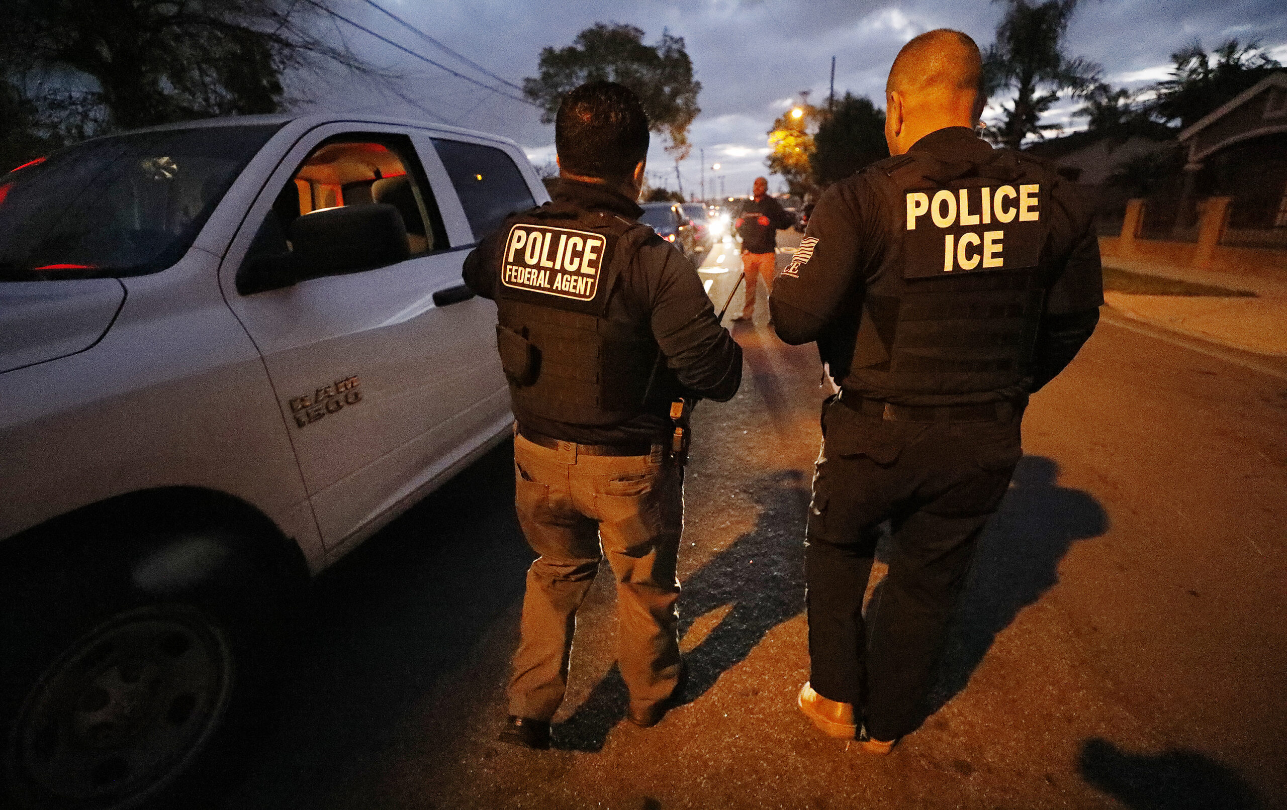 ICE agents apprehend someone in the early morning hours in Bell Gardens, California, in March 2020. (Al Seib/Los Angeles Times/TNS)