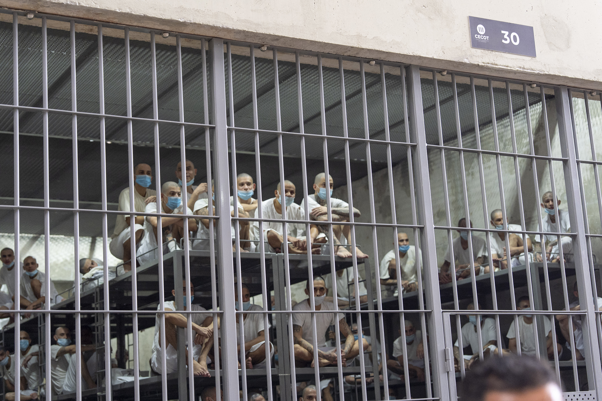 Prisoners look out of their cell at the Terrorist Confinement Center