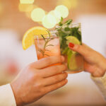 Two cocktail glasses in man and woman hand