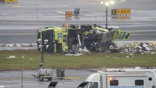A destroyed Port Authority emergency vehicle is pictured after it collided with an Air Canada Express plane at LaGuardia Airport in Queens, New York, on Sunday, March 22, 2026.
