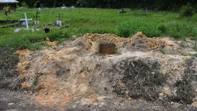 A view of an open grave at the cemetery of Cumuto, Trinidad and Tobago, taken on April 18, 2026. The remains of at least 50 infants and six adults were discovered on April 18, 2026, after they had apparently been discarded at a cemetery in Trinidad and Tobago, police said.