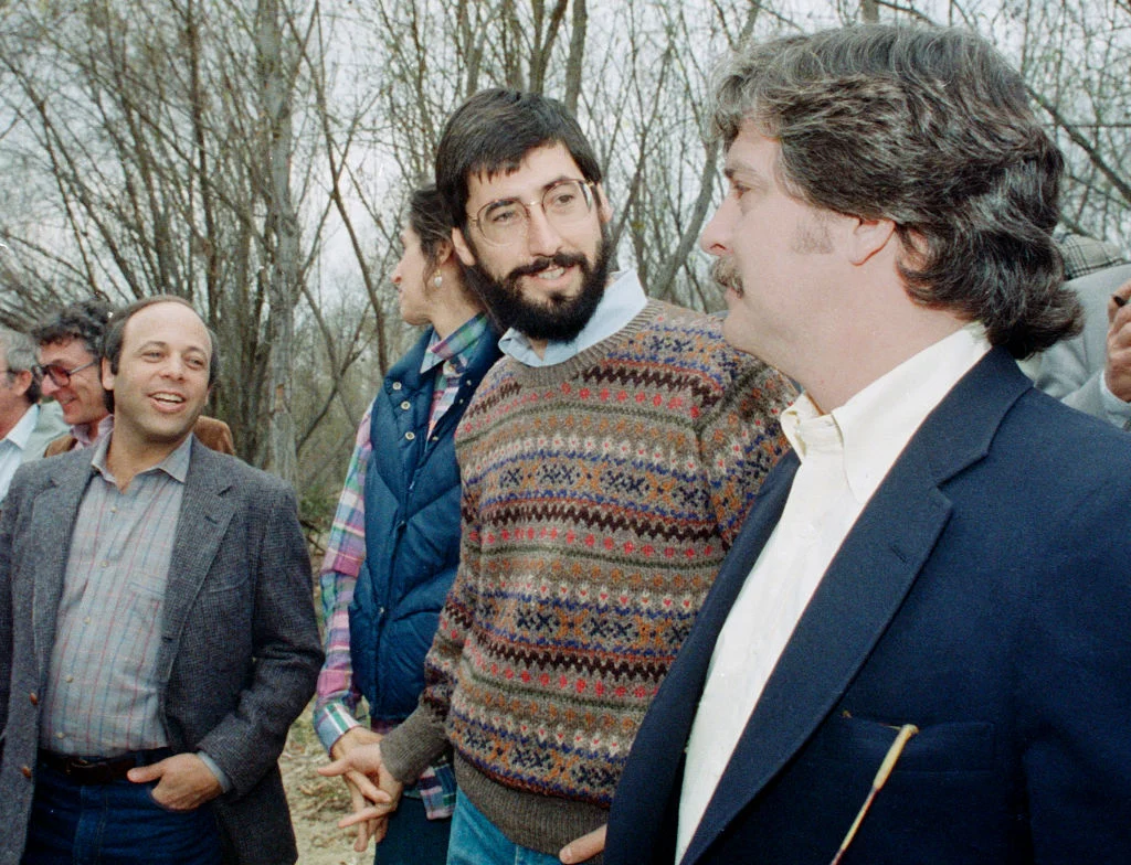 Director John Landis, talks with representative after a Los Angeles County Fire Department helicopter flew a similar route above the Santa Clara River where a 1982 helicopter filming accident killed actor Vic Morrow and two children by a disabled helicopter, February 10, 1987 in Saugus, California. Saugus is located just North of Los Angeles.
